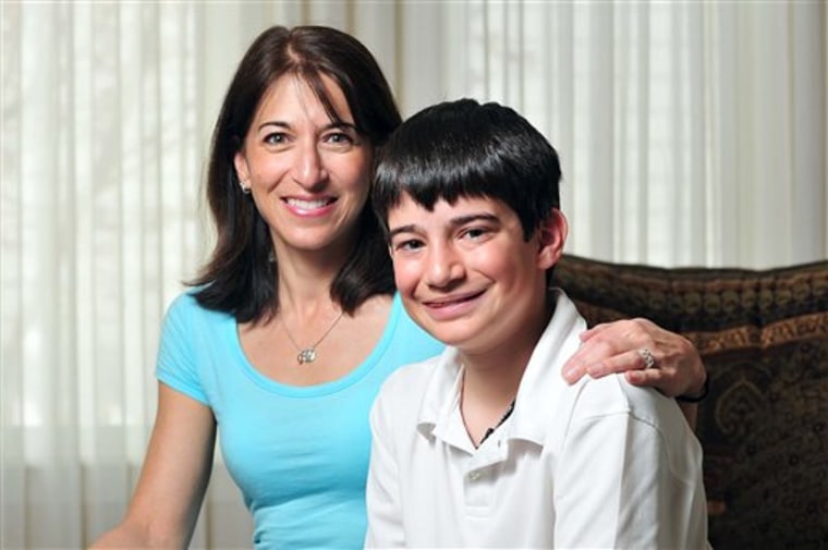 In this April 9 photo, Shalini Schane, left, and her son Adam, 13, pose in their home in Longmont, Colo. Shalini Schane's letter to President Barack Obama received national attention late Friday, April 8, when the president cited it prominently during his televised remarks about Congress' budget compromise.
